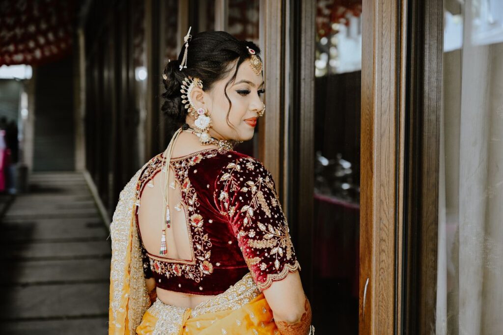 Beautiful Indian bride in traditional attire with intricate jewelry, captured in a serene pose.