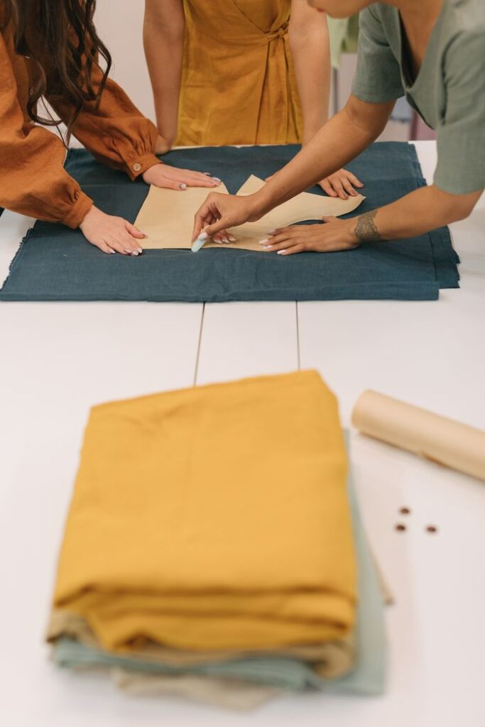 Collaborative dressmaking in action, showcasing teamwork and creativity in a sewing studio.